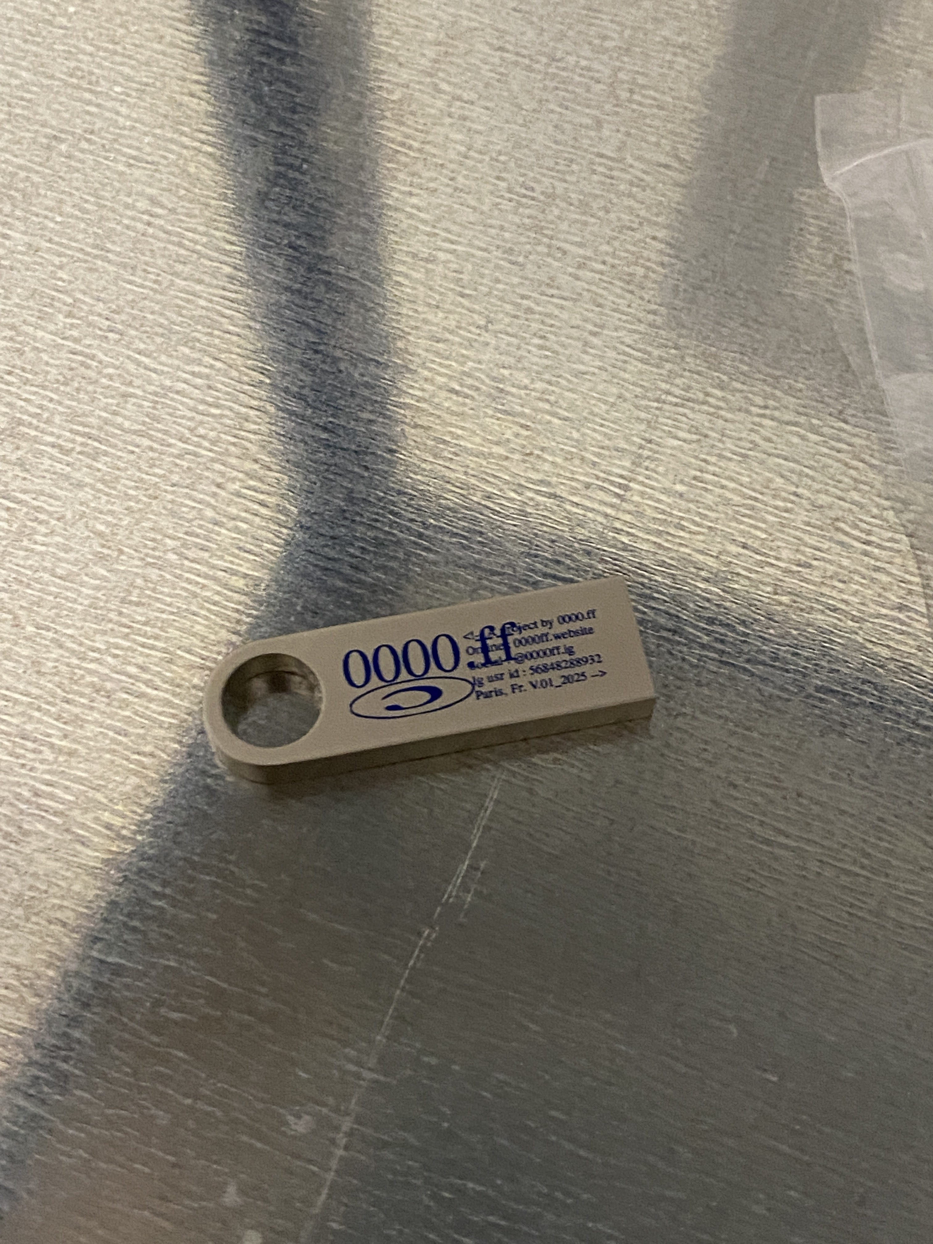 USB drive labeled 0000.ff with white design