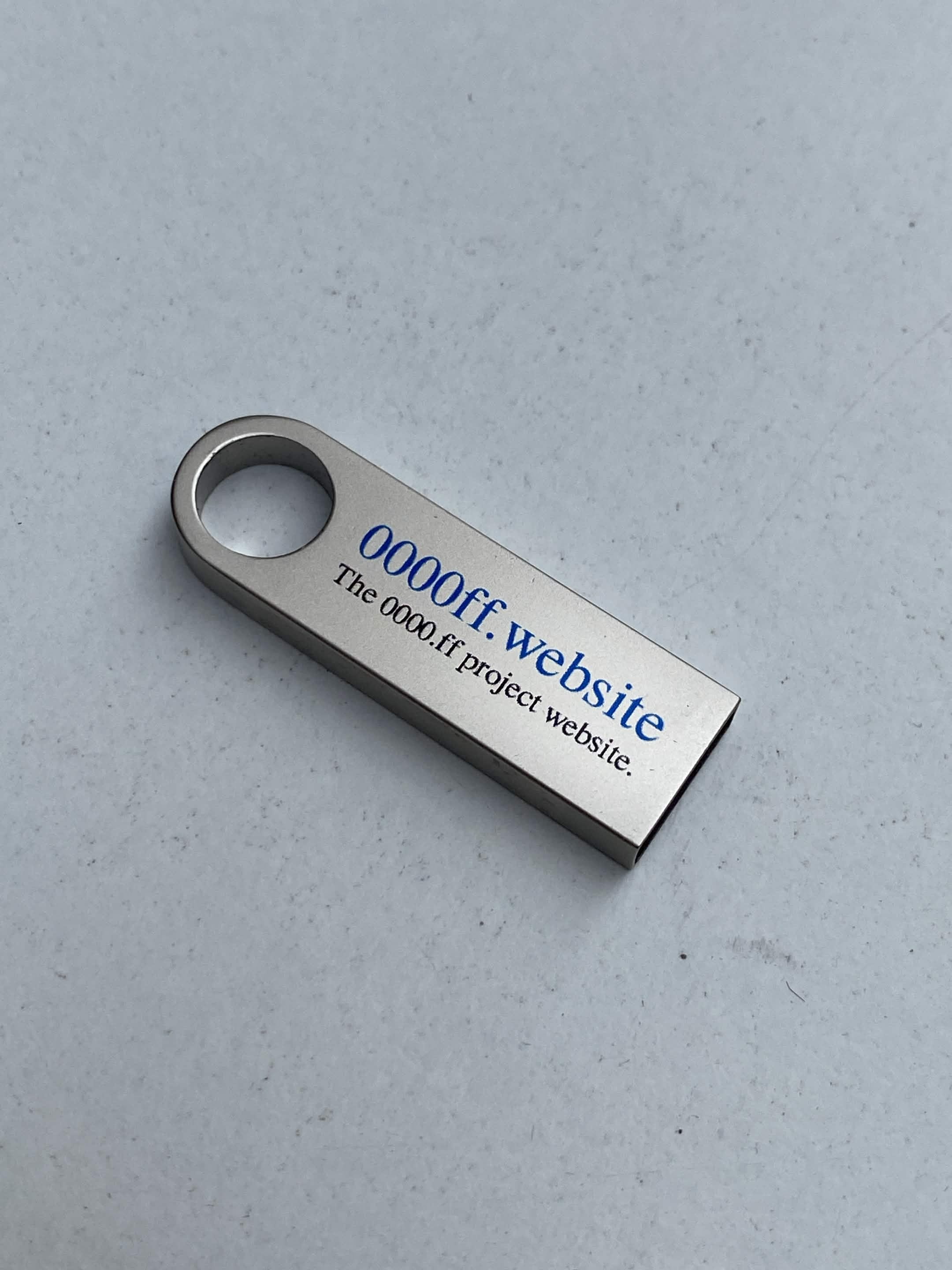 USB drive labeled 0000ff.website with white design